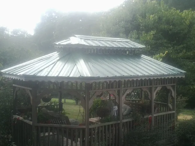 Two tier green metal roof on a garden gazebo in Calera